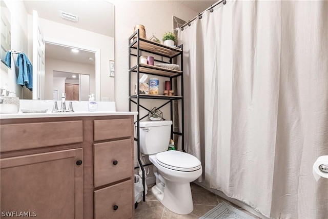 bathroom featuring toilet, vanity, and tile patterned floors