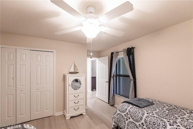 bedroom with ceiling fan, light hardwood / wood-style floors, and a closet