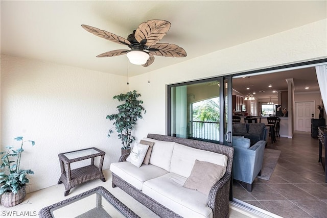 interior space with an outdoor hangout area and ceiling fan