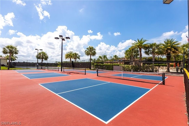 view of tennis court with basketball hoop