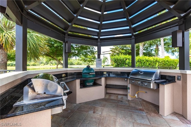 view of patio / terrace featuring a gazebo, area for grilling, and exterior kitchen