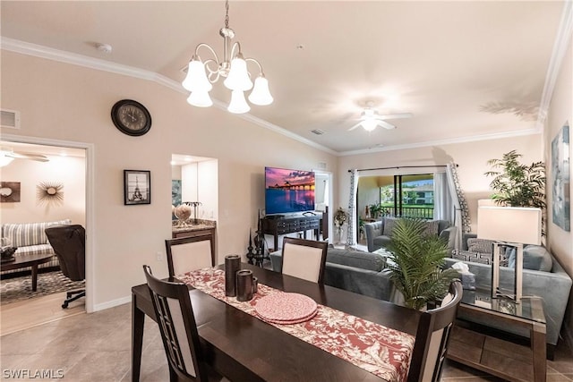 dining room featuring ceiling fan with notable chandelier, light tile patterned flooring, ornamental molding, and vaulted ceiling