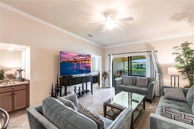 tiled living room with ceiling fan and crown molding