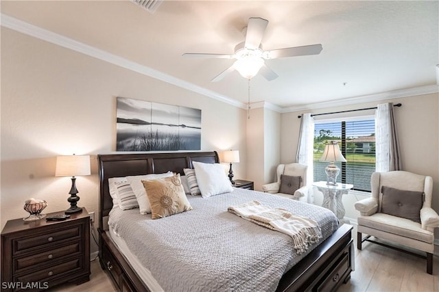 bedroom with ceiling fan, light hardwood / wood-style floors, and ornamental molding