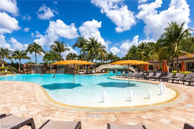 view of pool featuring pool water feature and a patio