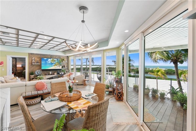 sunroom with an inviting chandelier