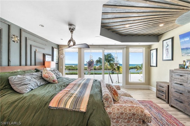 bedroom with light hardwood / wood-style floors and access to outside