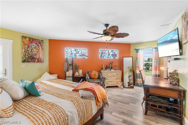 bedroom with access to outside, ceiling fan, and light wood-type flooring