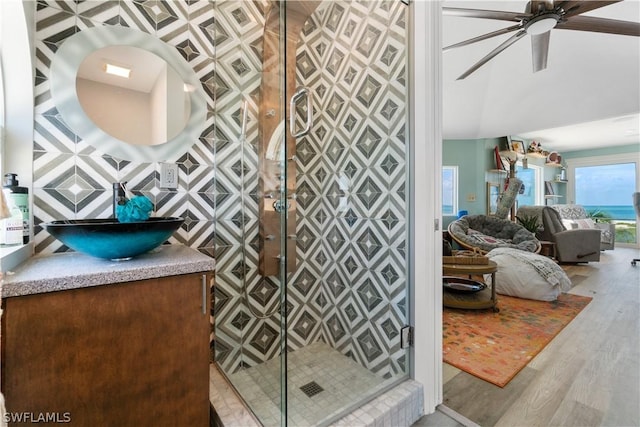 bathroom with hardwood / wood-style flooring, vanity, an enclosed shower, and ceiling fan