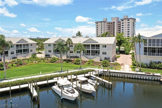 exterior space with a water view and a lawn