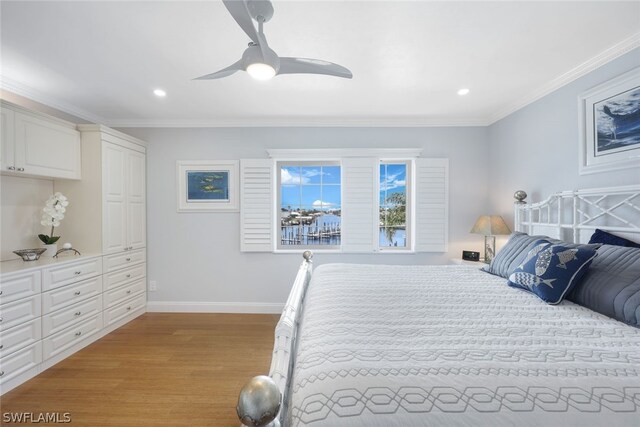 bedroom with ornamental molding, wood-type flooring, and ceiling fan