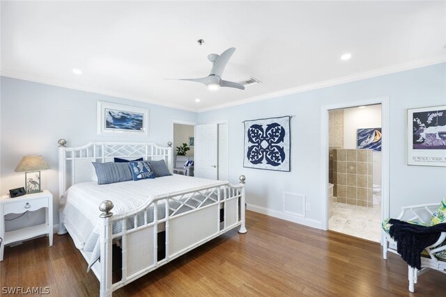 bedroom featuring ensuite bath, dark wood-type flooring, ceiling fan, and crown molding