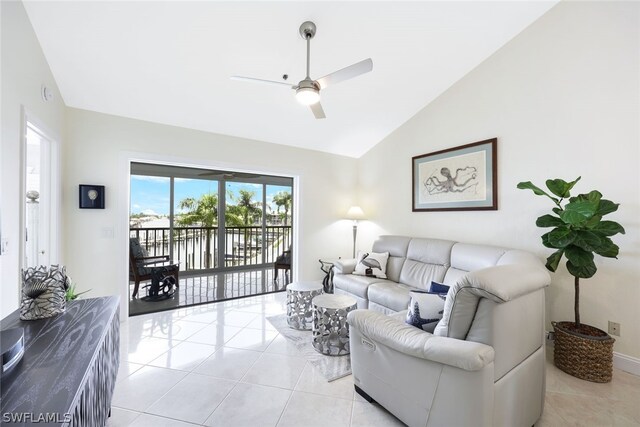 tiled living room with lofted ceiling and ceiling fan