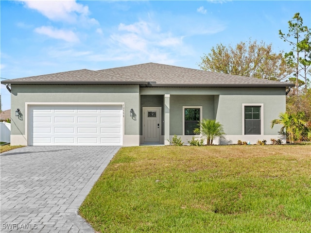 view of front of property featuring a front lawn and a garage