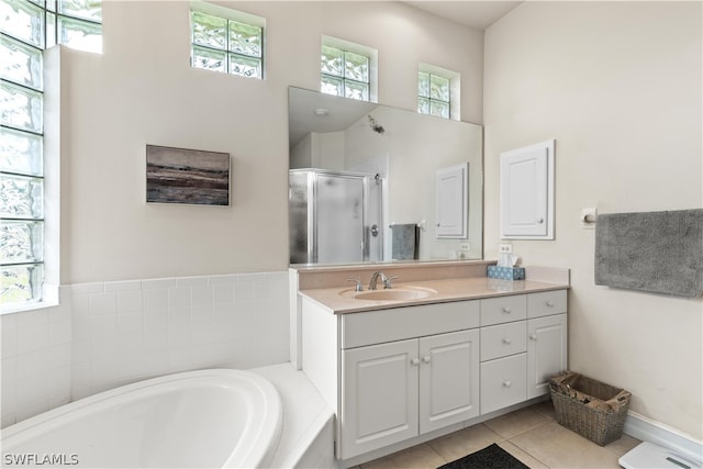 bathroom with tile floors, a towering ceiling, separate shower and tub, and large vanity