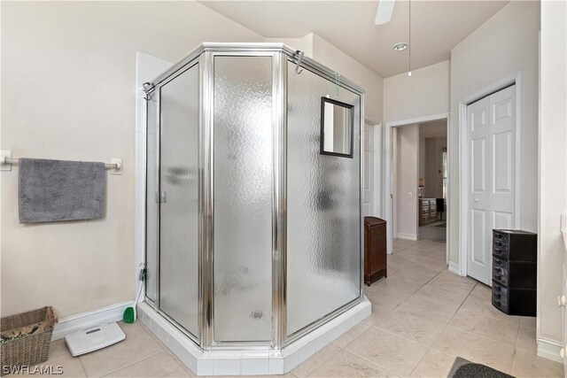 bathroom featuring tile flooring and a shower with shower door