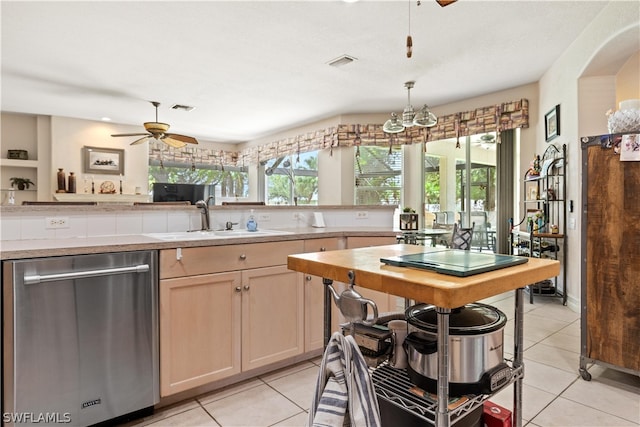 kitchen featuring sink, light tile flooring, dishwasher, and ceiling fan