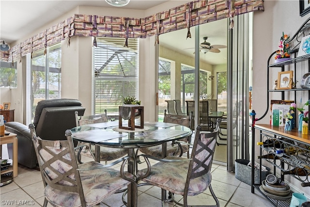 dining space with a healthy amount of sunlight, ceiling fan, and light tile floors