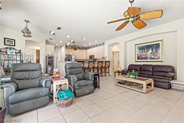 tiled living room featuring ceiling fan