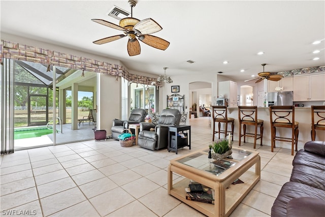 tiled living room featuring a wealth of natural light and ceiling fan