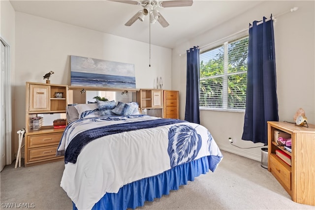 bedroom with light colored carpet and ceiling fan