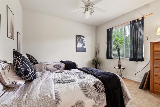 bedroom featuring light carpet and ceiling fan