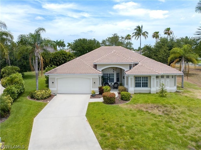 view of front of home with a garage, concrete driveway, a front yard, and a tile roof