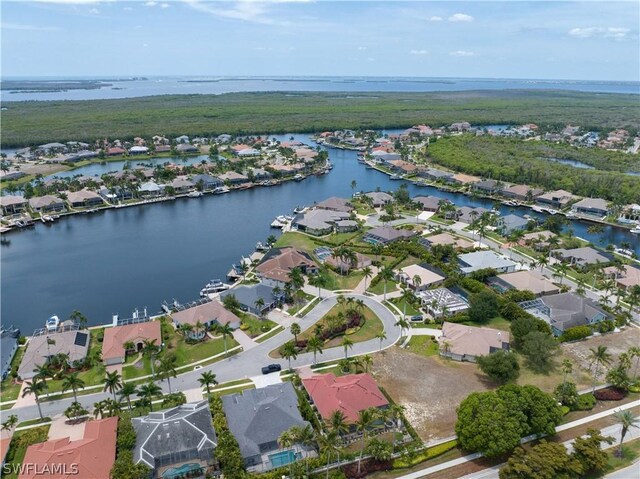 drone / aerial view with a water view and a residential view