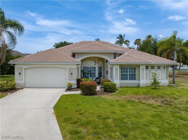 ranch-style home with a front lawn and a garage