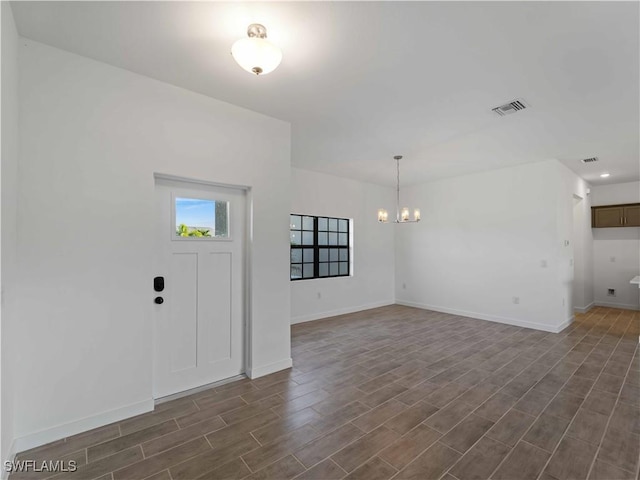 2917 NW 19th Ter, Cape Coral, FL 33993 - foyer entrance with a chandelier, dark wood-style flooring, and baseboards