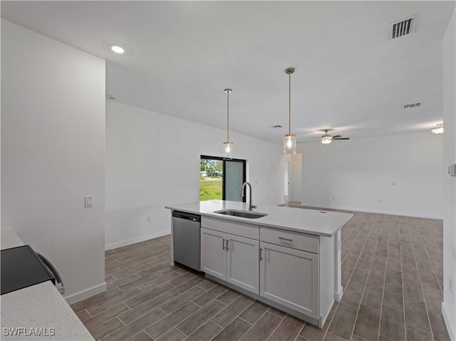 2917 NW 19th Ter, Cape Coral, FL 33993 - kitchen with stainless steel dishwasher, a sink, wood tiled floors, light countertops, and recessed lighting