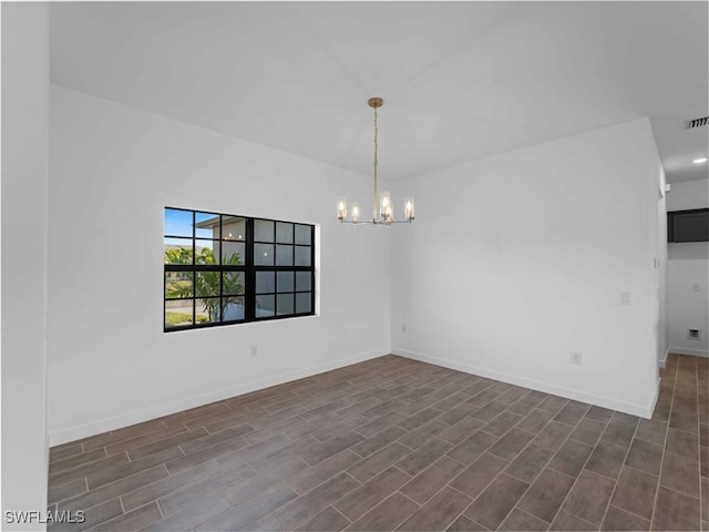 2917 NW 19th Ter, Cape Coral, FL 33993 - unfurnished room featuring a chandelier, baseboards, and dark wood-style floors