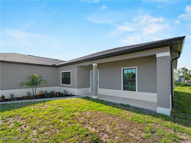 2917 NW 19th Ter, Cape Coral, FL 33993 - back of house featuring a lawn and stucco siding