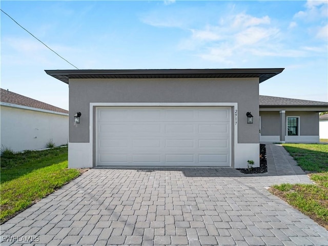 2917 NW 19th Ter, Cape Coral, FL 33993 - view of front of property with stucco siding, decorative driveway, and an attached garage