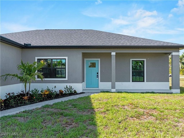 2917 NW 19th Ter, Cape Coral, FL 33993 - view of front of property with a front yard, a shingled roof, and stucco siding