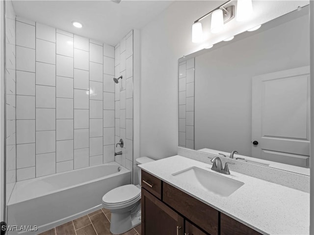 2917 NW 19th Ter, Cape Coral, FL 33993 - bathroom featuring toilet, wood tiled floors, shower / tub combination, vanity, and recessed lighting