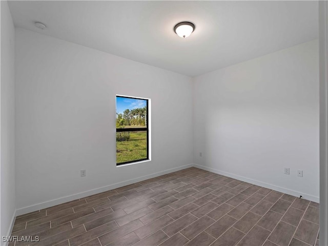 2917 NW 19th Ter, Cape Coral, FL 33993 - spare room with wood tiled floors, baseboards, and a smoke detector