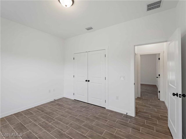 2917 NW 19th Ter, Cape Coral, FL 33993 - unfurnished bedroom with dark wood finished floors, baseboards, and a closet