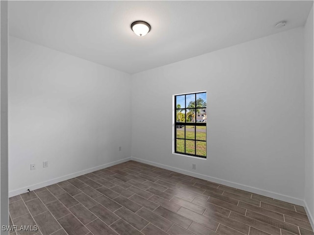 2917 NW 19th Ter, Cape Coral, FL 33993 - unfurnished room with baseboards and dark wood-type flooring