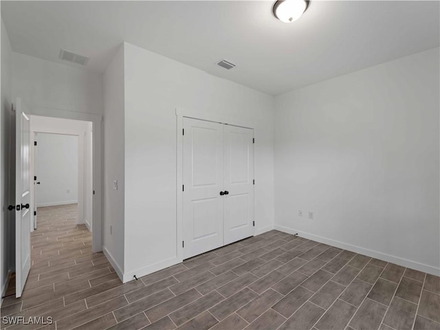 2917 NW 19th Ter, Cape Coral, FL 33993 - unfurnished bedroom with wood finish floors, baseboards, and a closet