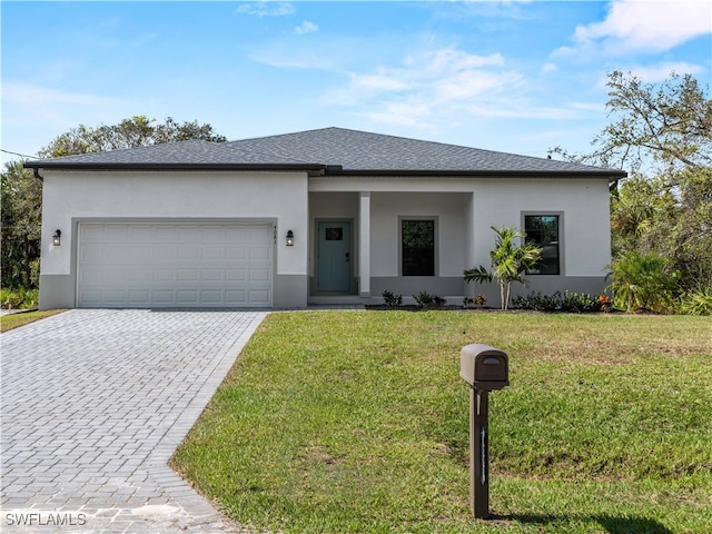 view of front of house with a front lawn and a garage