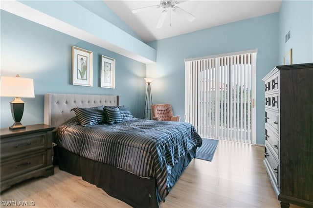 bedroom featuring access to exterior, light hardwood / wood-style floors, vaulted ceiling, and ceiling fan