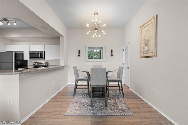 dining room featuring a chandelier and light hardwood / wood-style floors