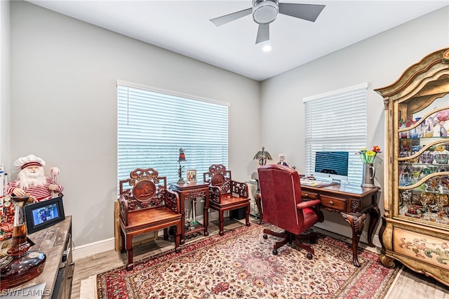 home office featuring wood-type flooring and ceiling fan