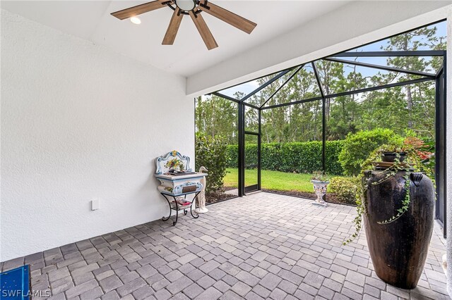 unfurnished sunroom with ceiling fan