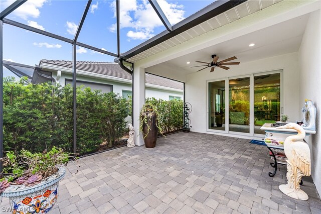 unfurnished sunroom featuring ceiling fan