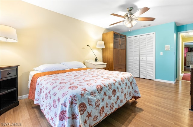 bedroom featuring ceiling fan, a closet, and light wood-type flooring