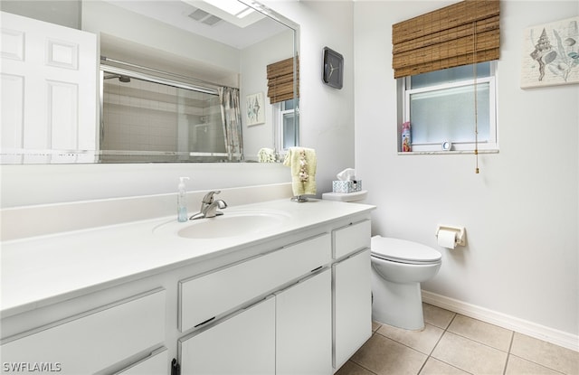 bathroom with an enclosed shower, vanity, tile patterned flooring, and toilet