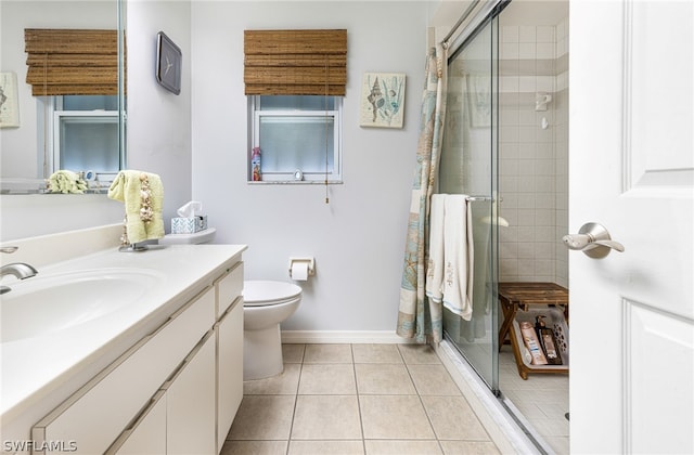 bathroom featuring vanity, toilet, tile patterned floors, and a shower with door