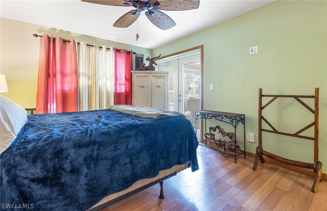 bedroom with access to outside, ceiling fan, french doors, and wood-type flooring